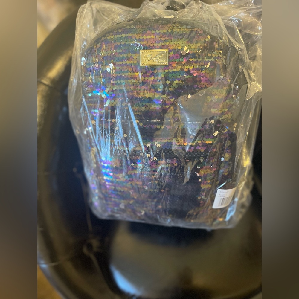 Brand new Betsey Johnson sparkly backpack bag. New with tags and in plastic.